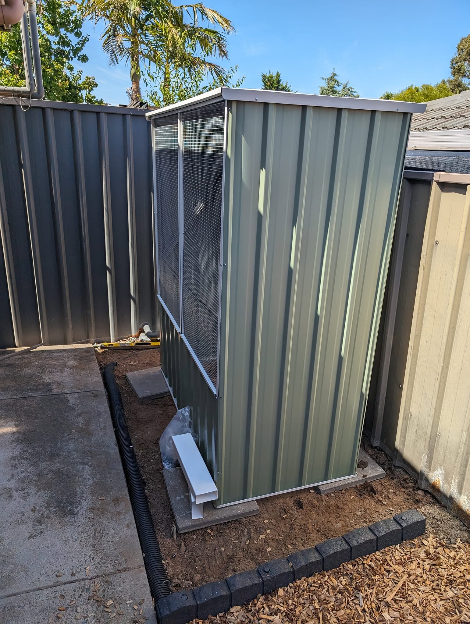 The same shed from the side, sitting square on its paver base