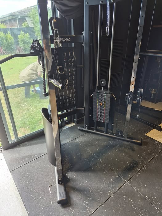 Home gym cable machine assembled in a garage
