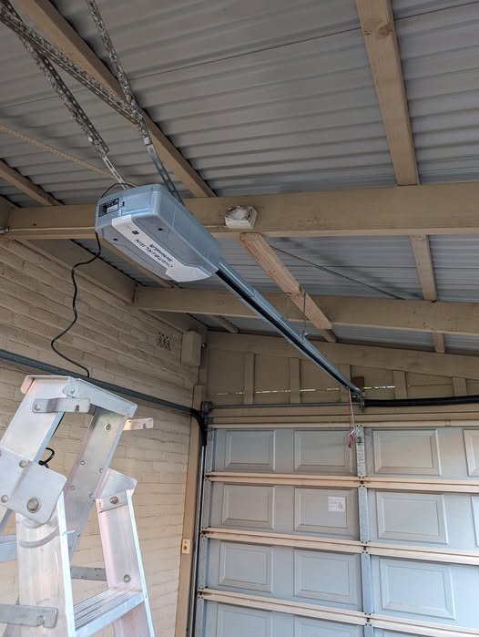 Electric opener installed above a sectional garage door