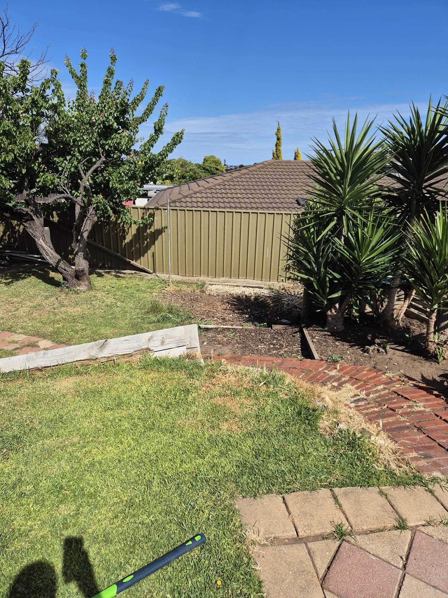 The same corner of the yard cleared and levelled after the shed was removed