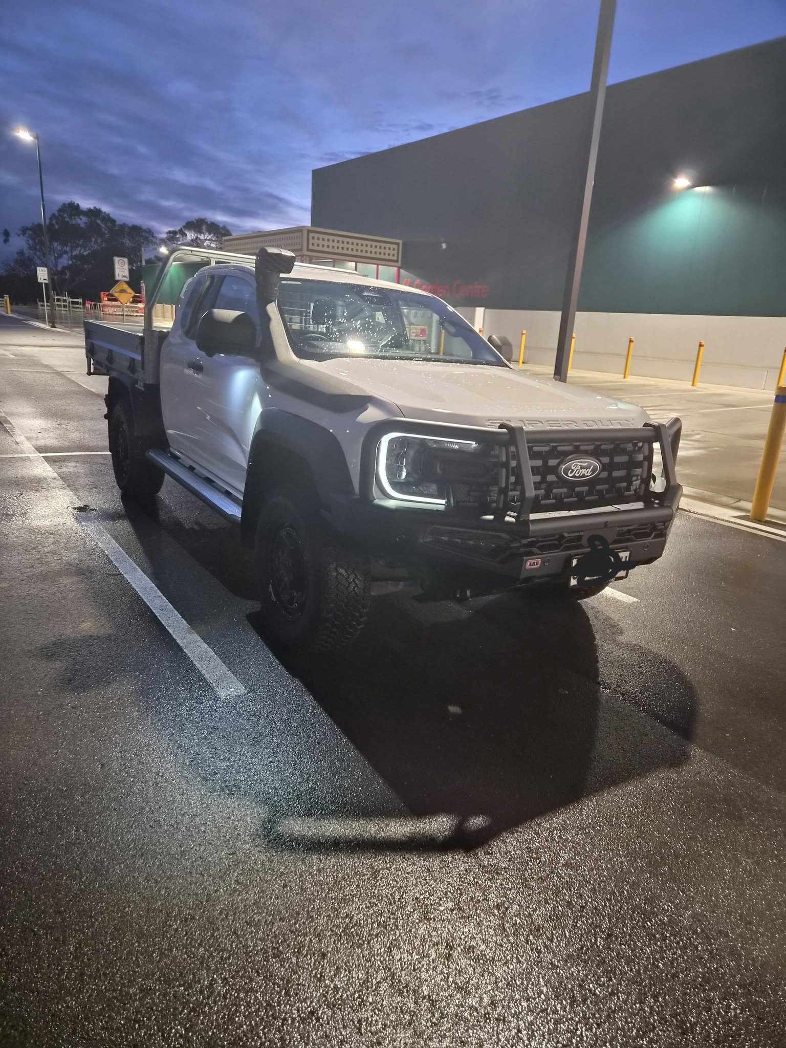 Work ute fitted with a bull bar and tray, set up for towing